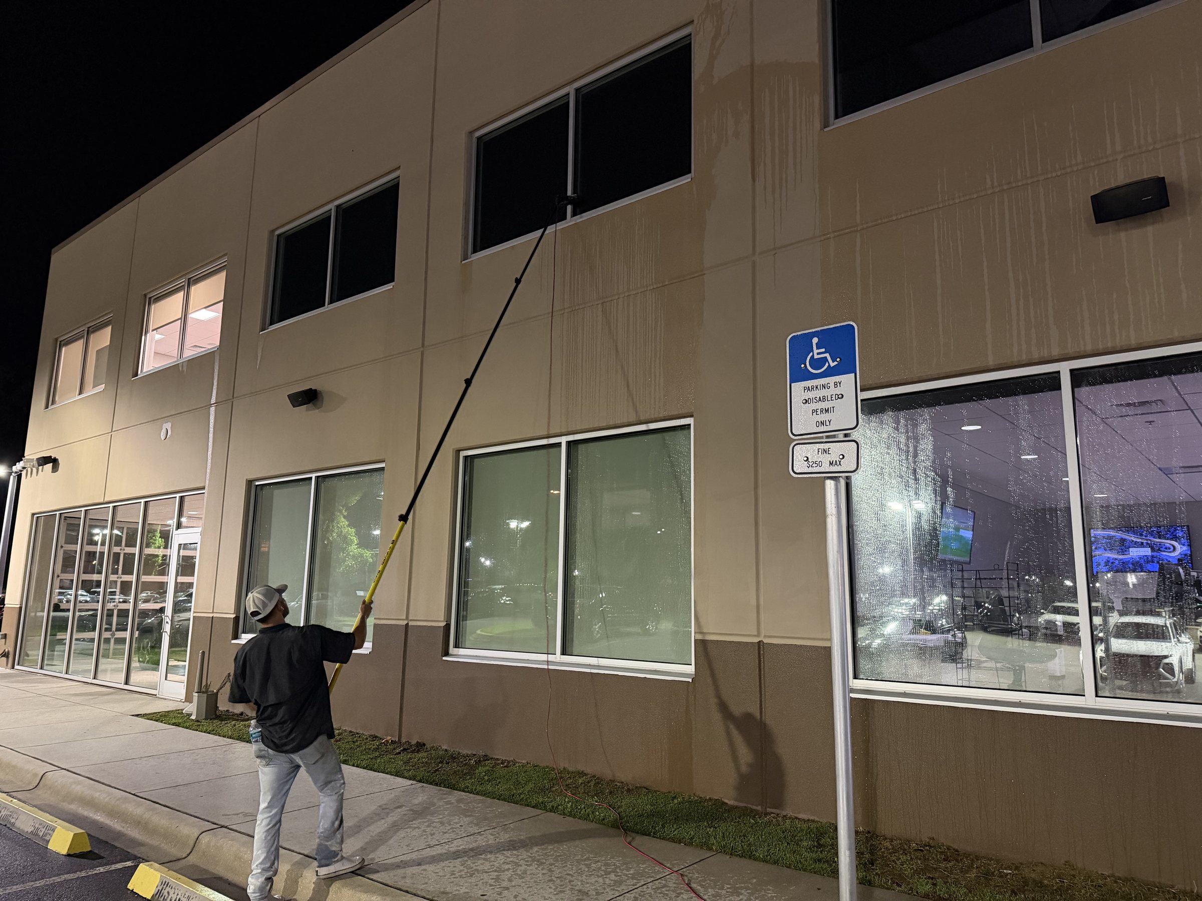 Storefront window cleaning at night