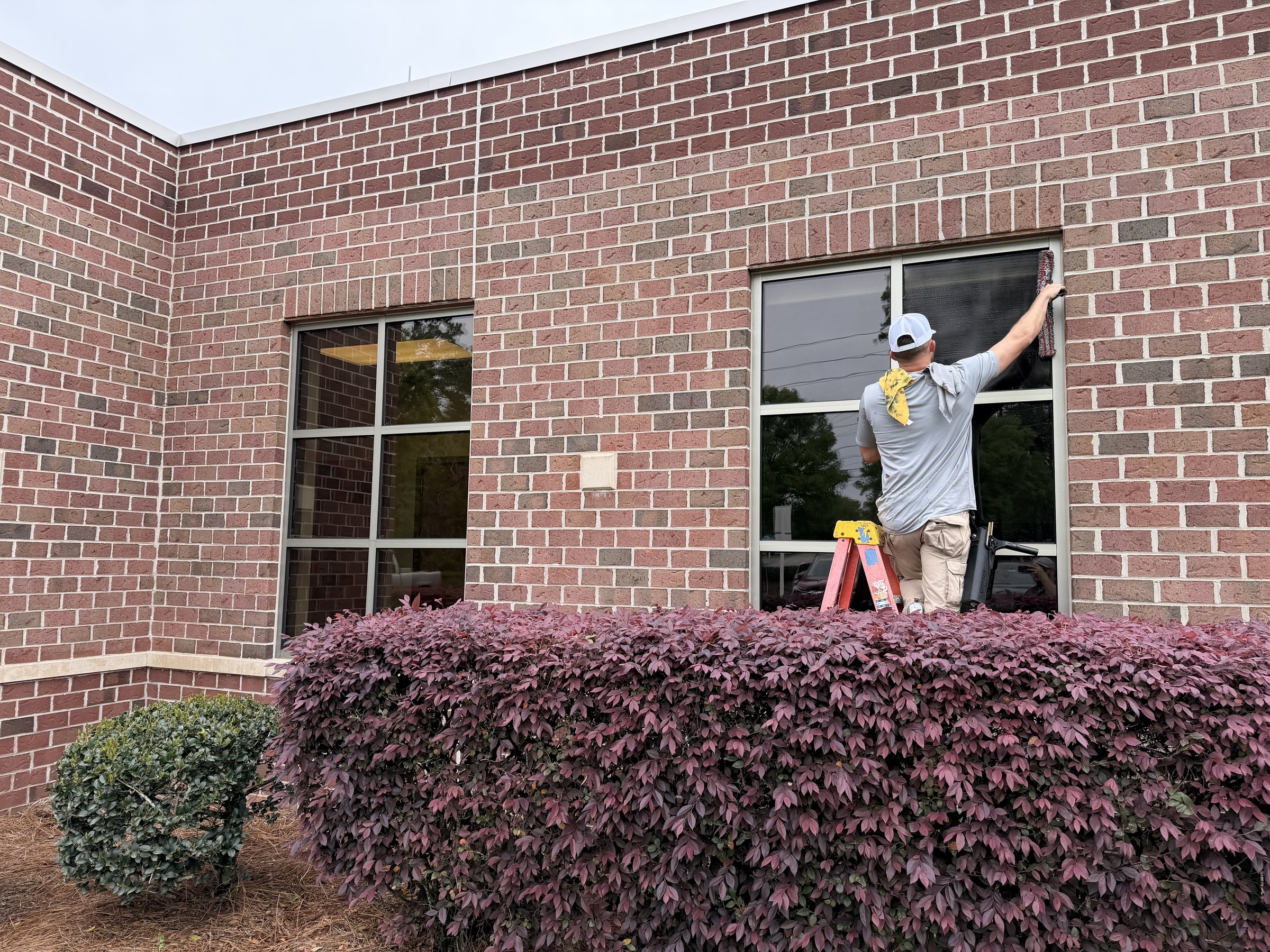 Water Works technician cleaning windows by hand